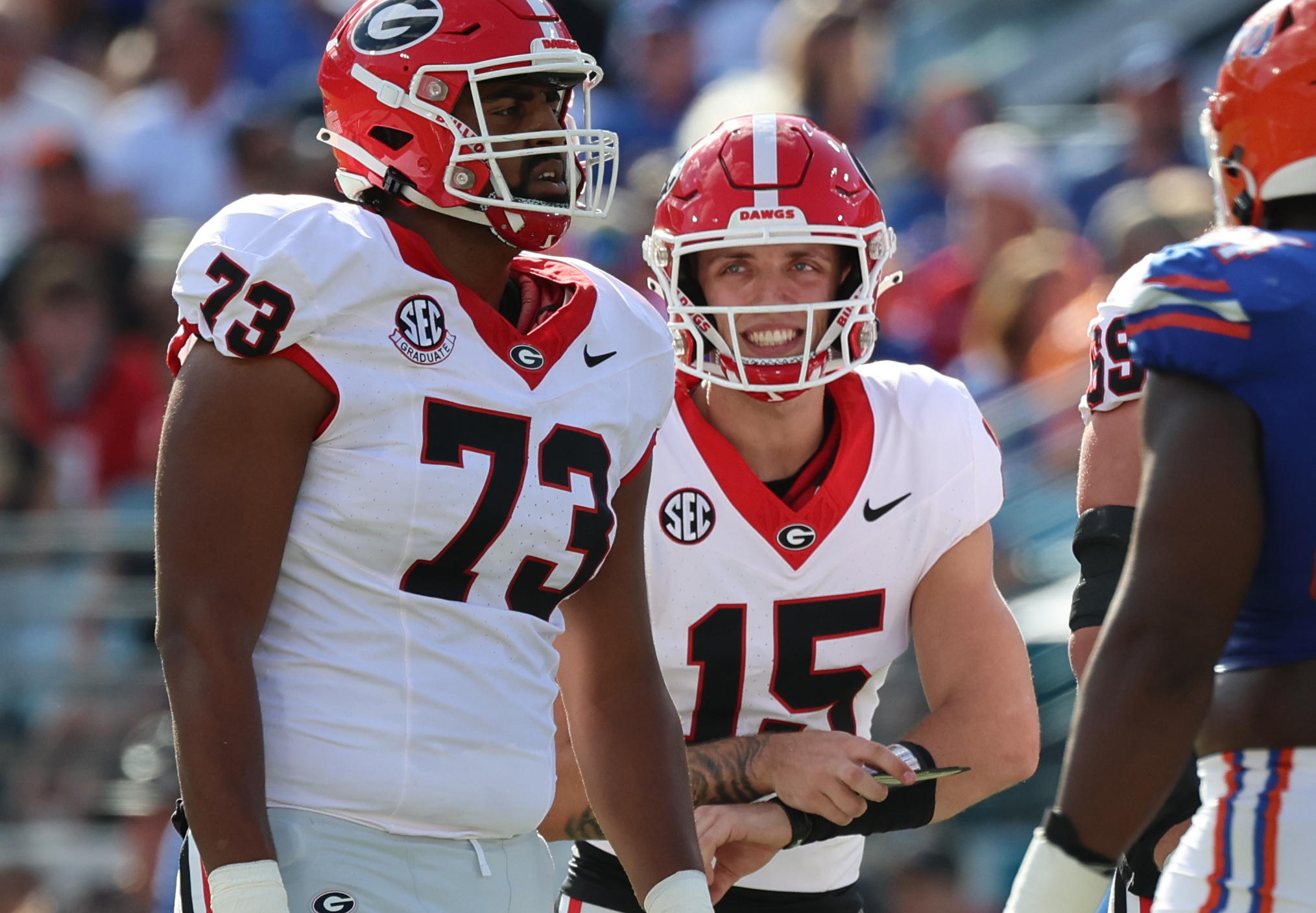 Oct 28, 2023; Jacksonville, Florida, USA; Georgia Bulldogs quarterback Carson Beck (15) calls a play to offensive lineman Xavier Truss (73) against the Florida Gators during the first quarter at EverBank Stadium. (Kim Klement Neitzel / USA TODAY Sports).